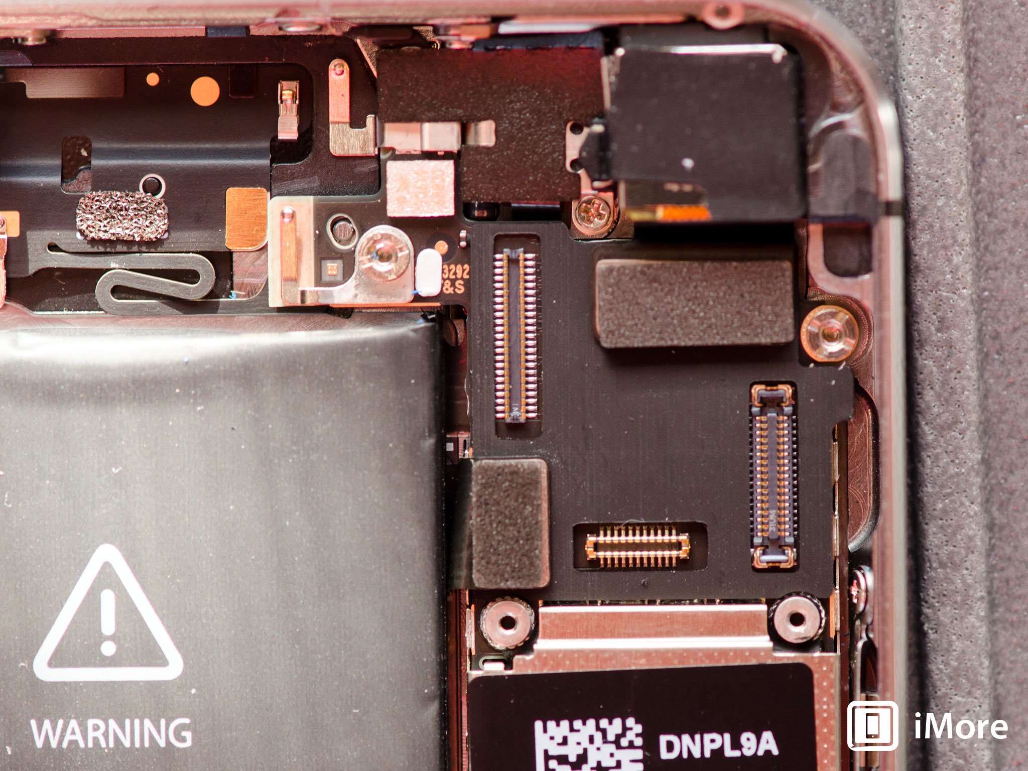 A look at where the digitizer, LCD, and front facing camera assembly cables attach to the iPhone 5s logic board