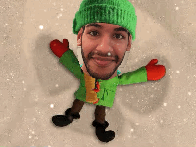 A GIF showing an animated character making a snow angel. My face has been superimposed over the character&#39;s face.