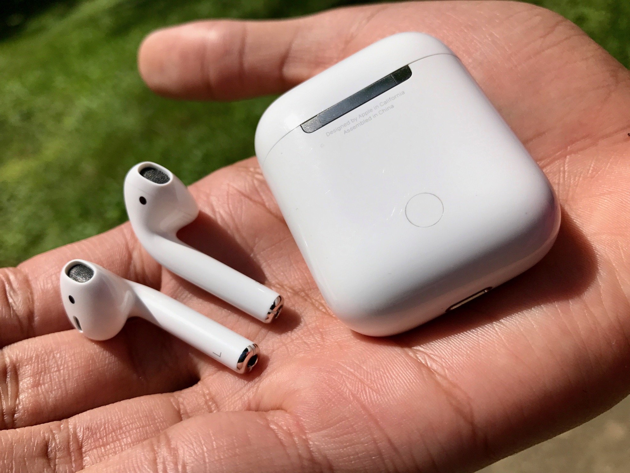 AirPods and case in a hand