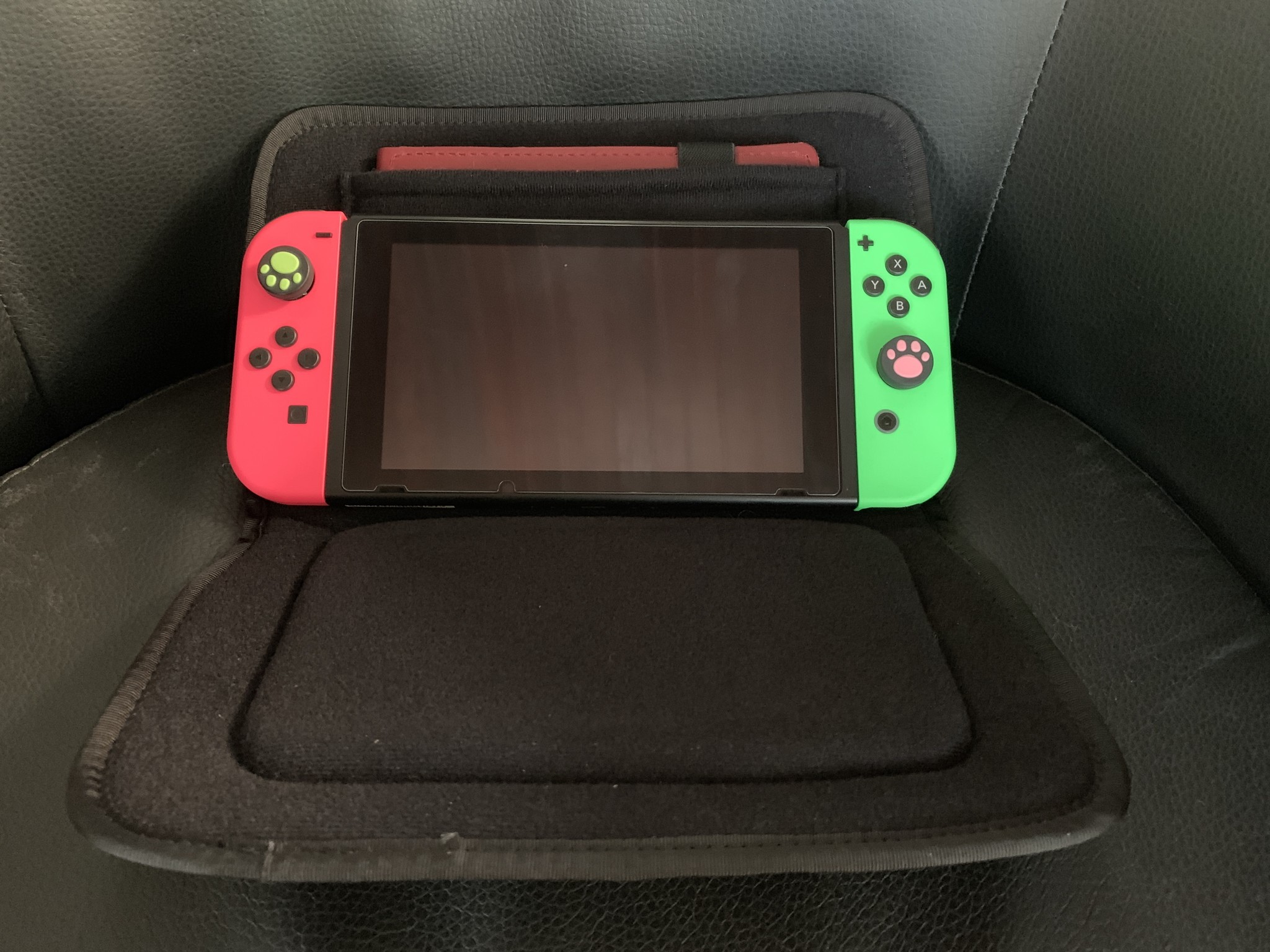 Waterfield Designs Switch Taco folded open revealing Nintendo Switch with Neon Green and Pink Joy-Con inside