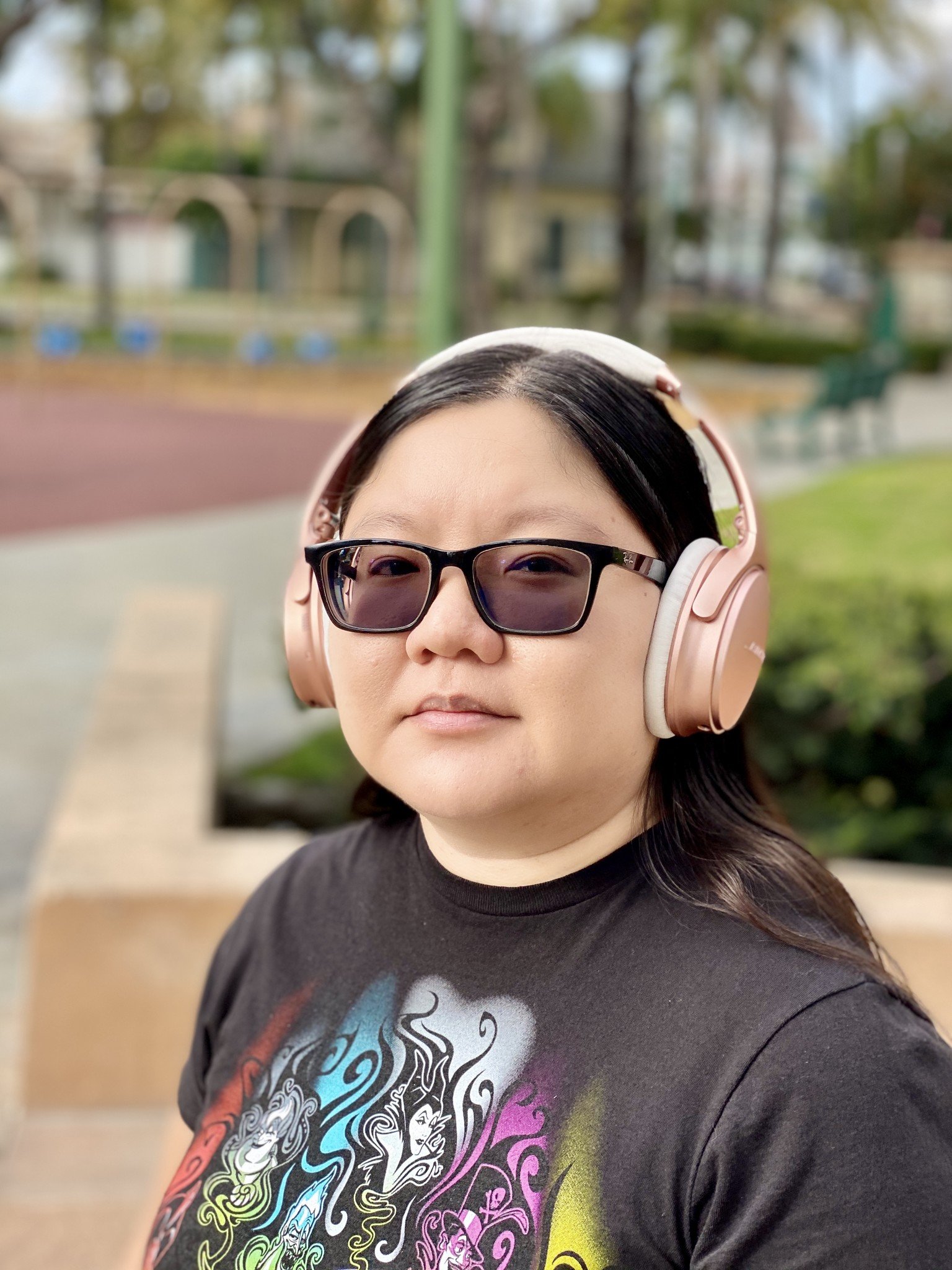 Christine wears Rose Gold Bose QuietComfort 35 II headphones