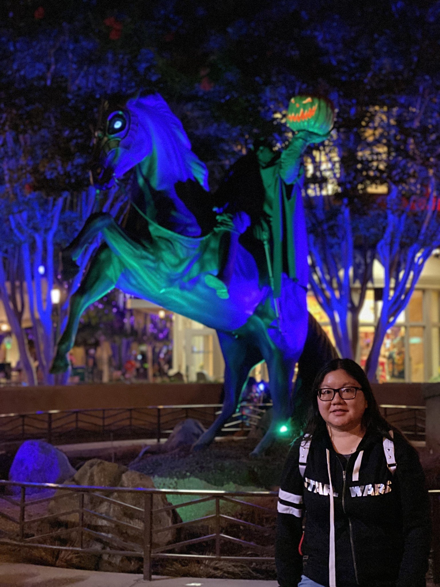 Christine poses for a portrait in front of the Headless Horseman at Disney California Adventure during Halloween