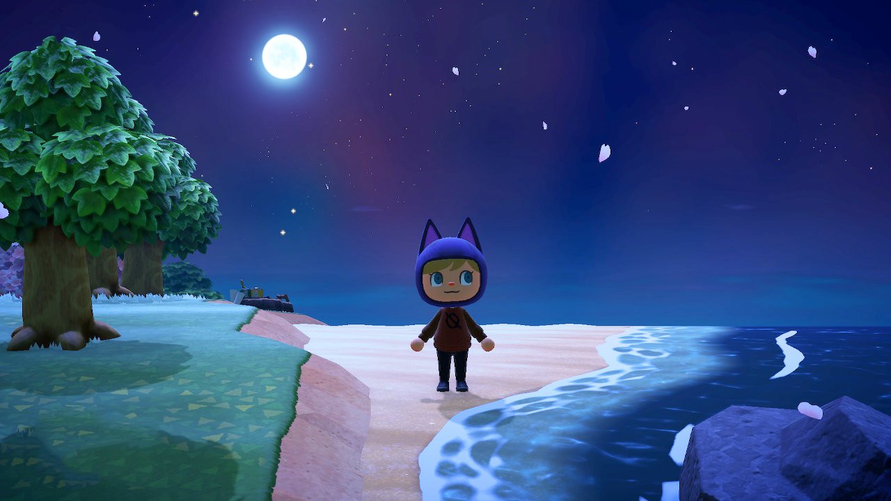 Player standing next to the ocean at night