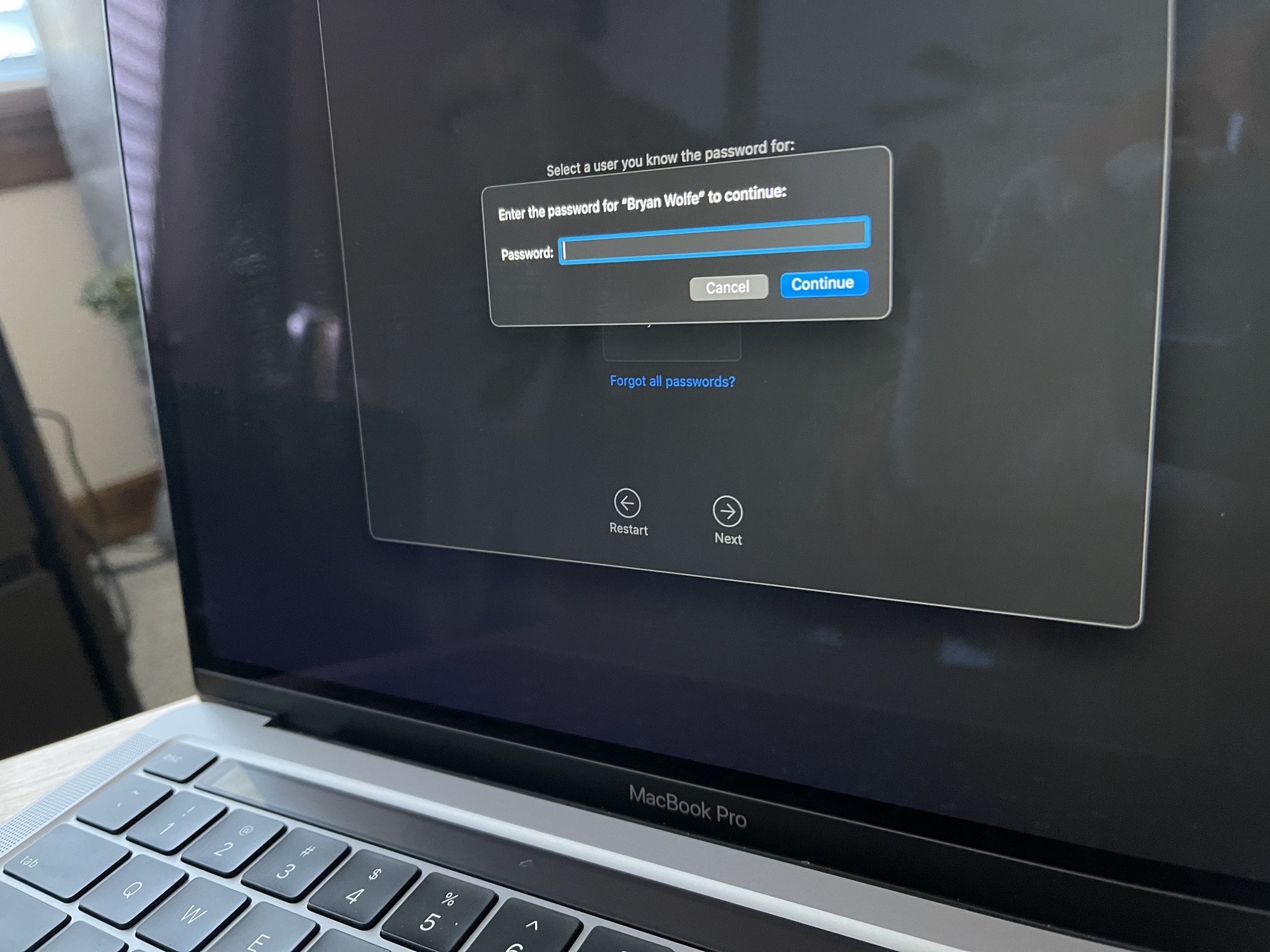 To restore your Mac to factory settings, log into the user account using the password. Choose Continue.