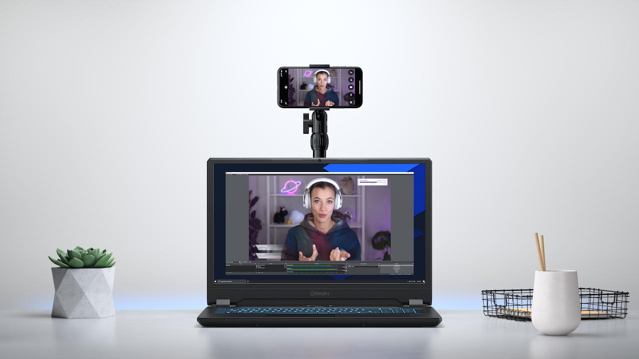 Official Elgato press photo for EpocCam, showing a webcam using EpocCam to stream video to a laptop.