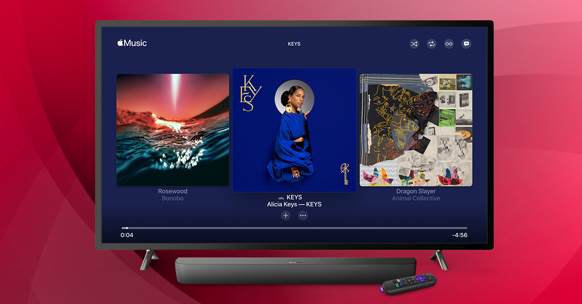 Apple Music on a television with Roku devices in front