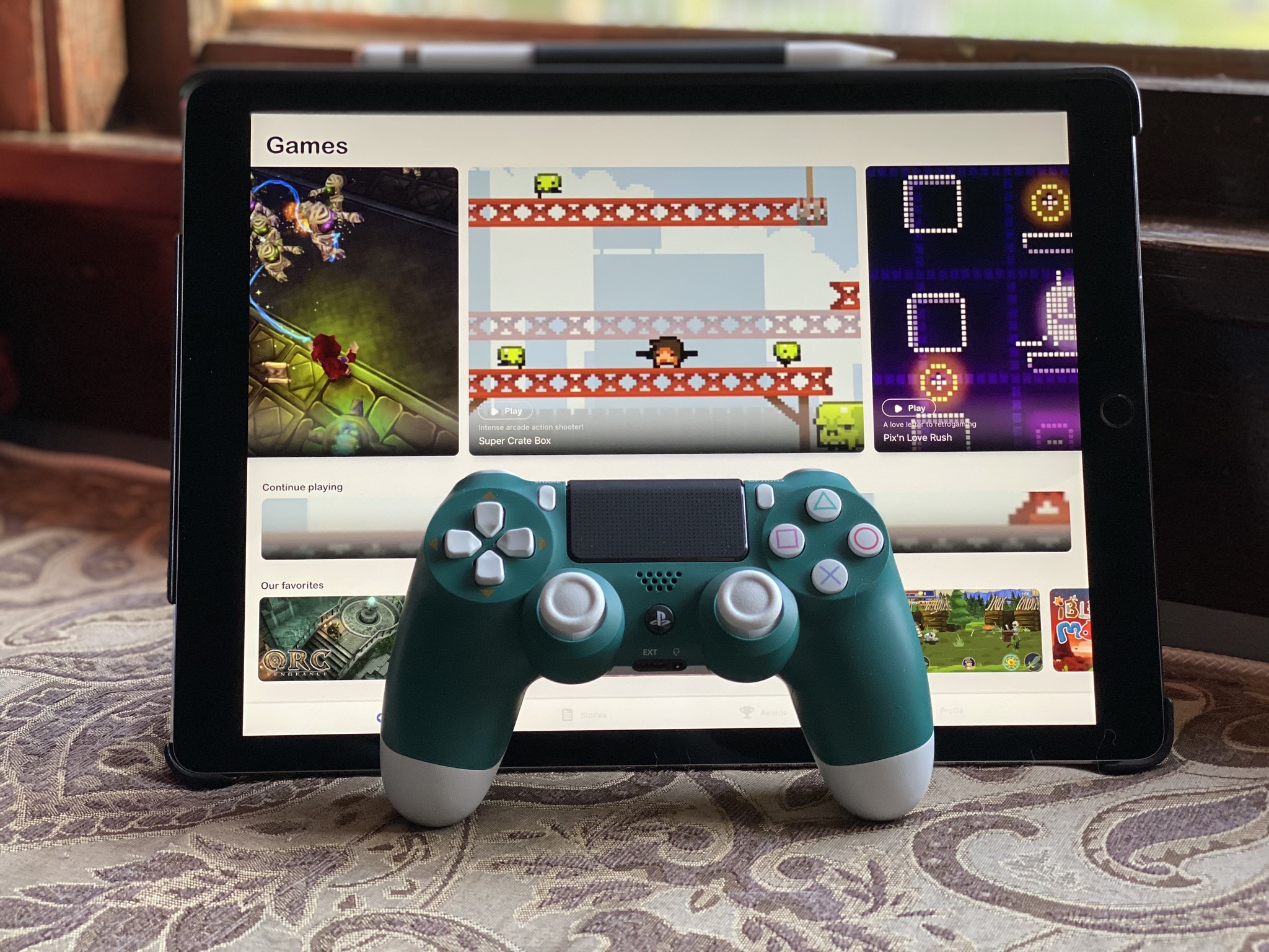 iPad Pro with GameClub and a green DualShock 4 controller