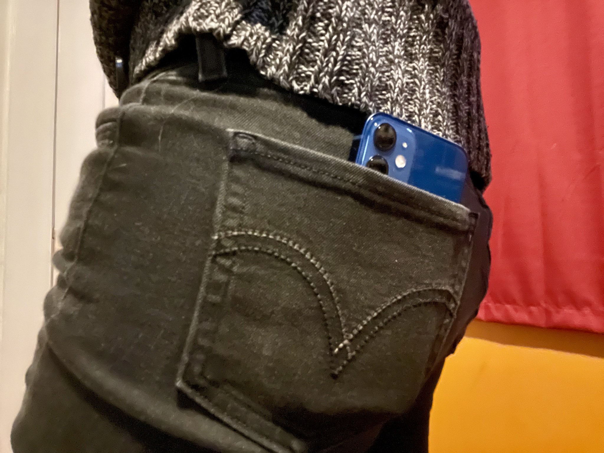 iPhone 12 mini in a back pocket of skinny jeans