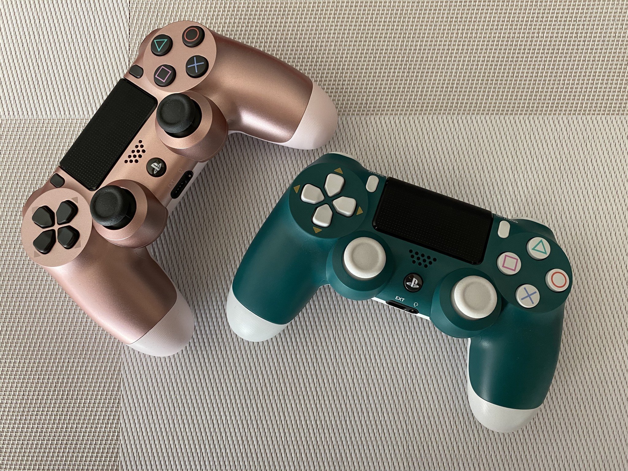 Rose Gold and Alpine Green DualShock 4 controllers