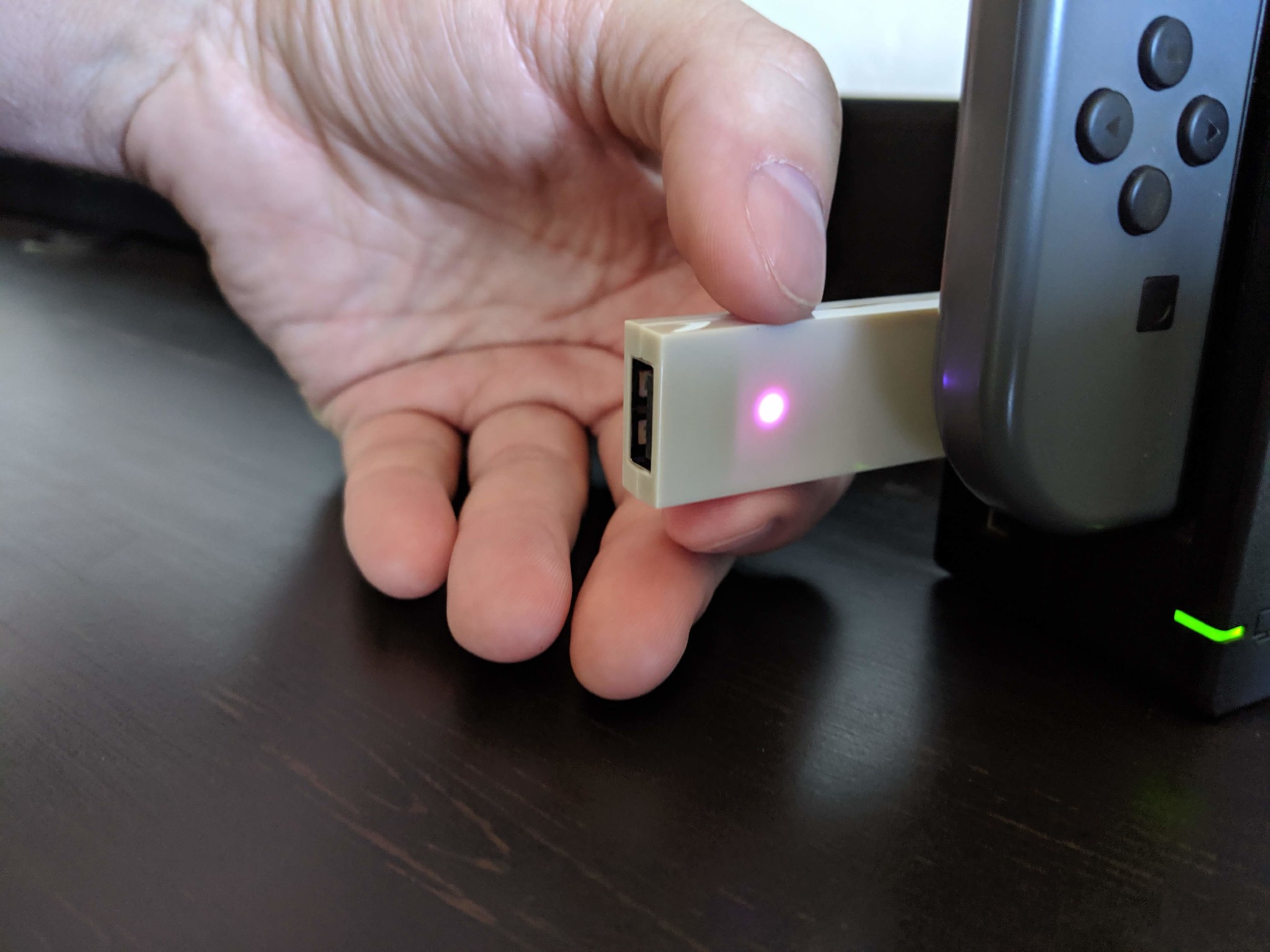 How to connect your Xbox One controller with the Nintendo Switch in wireless docked mode step three: Quickly press and release the small black button to make the LED flash faster