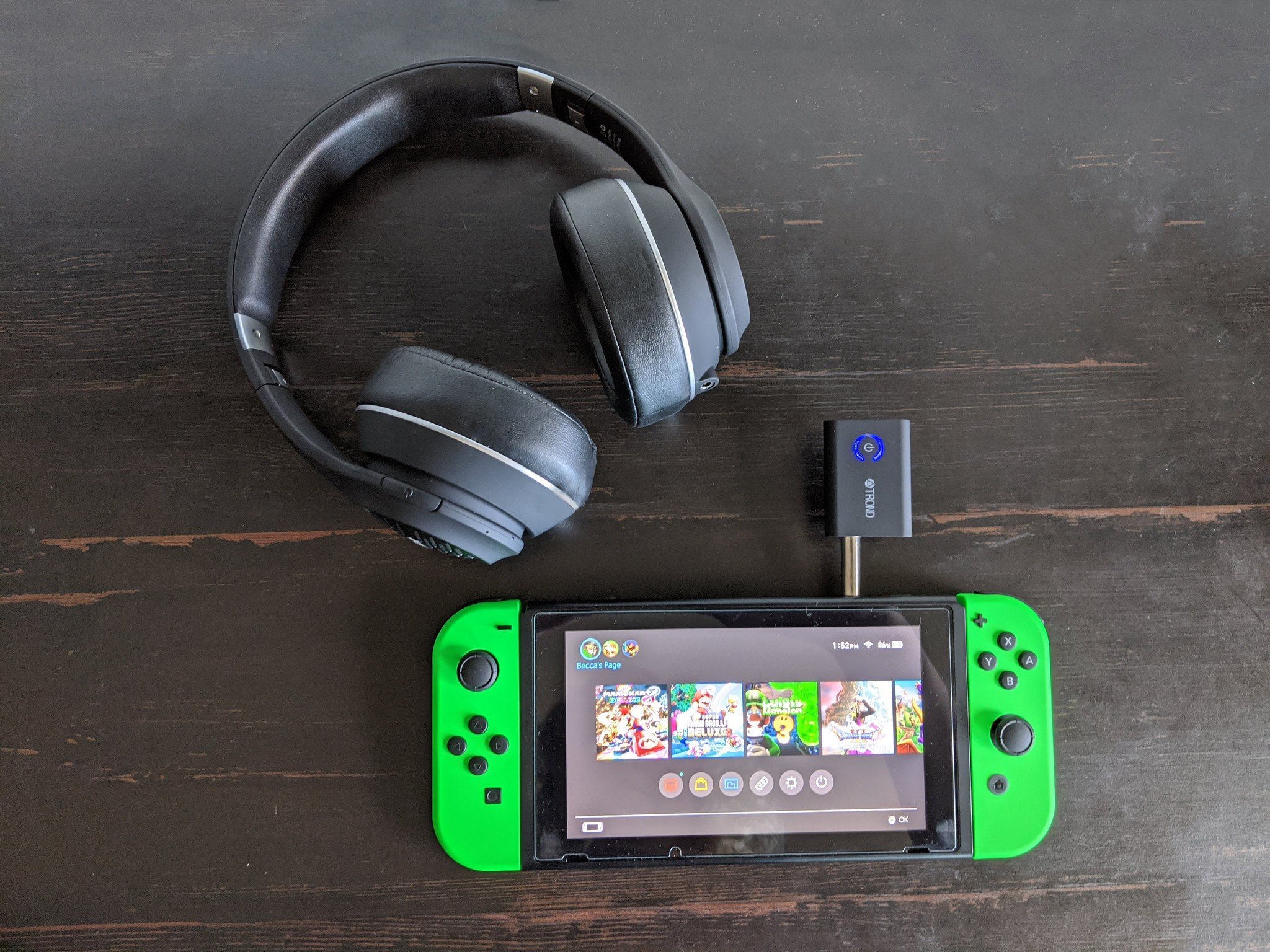 How to use Bluetooth headphones with a Nintendo Switch via the headphone jack: place your headphones and the adapter near each other and allow them to pair, it's successful when the transmitter's blue LED remains constant