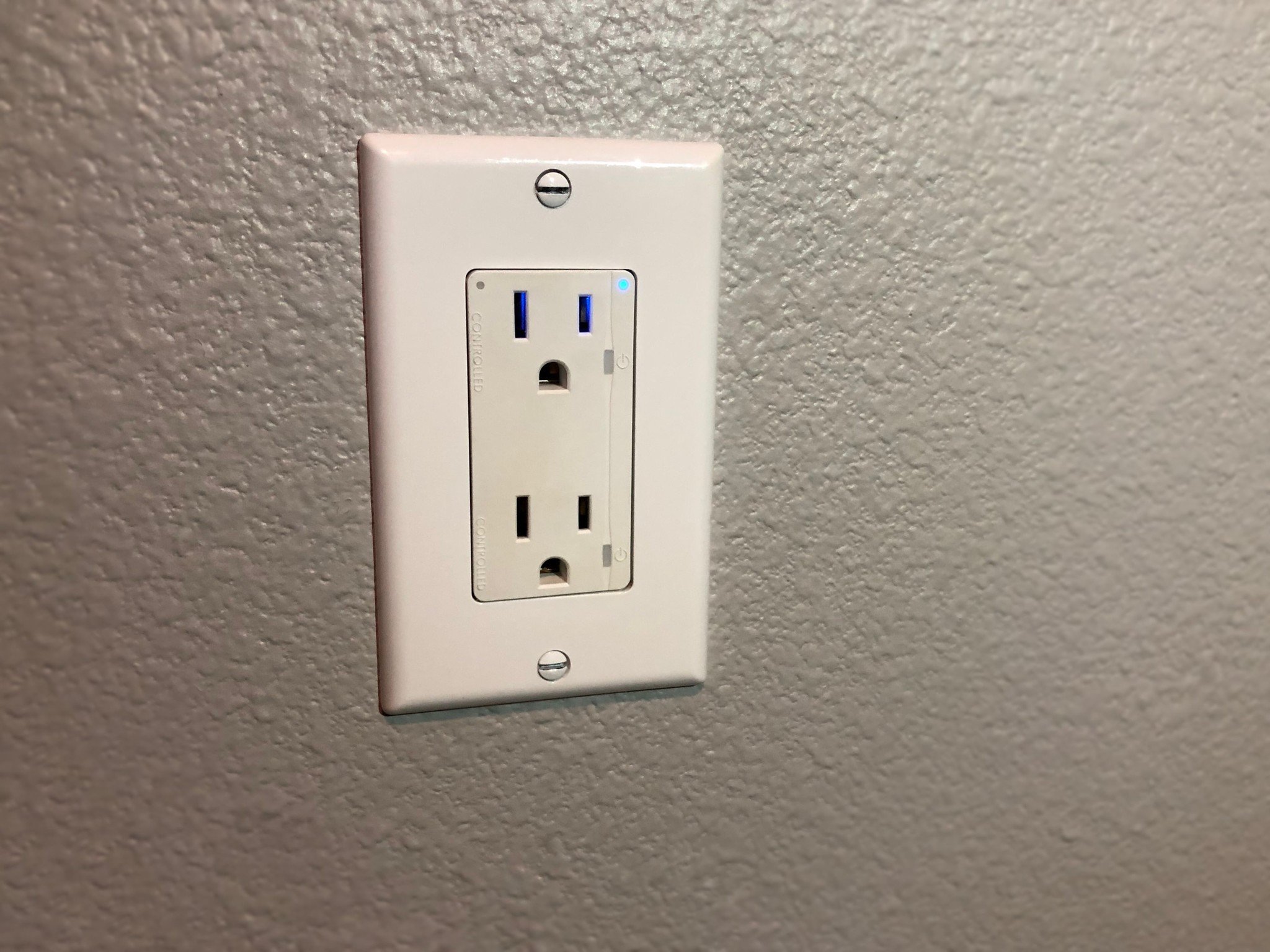 Connectsense Smart Inwall Outlet on a gray wall