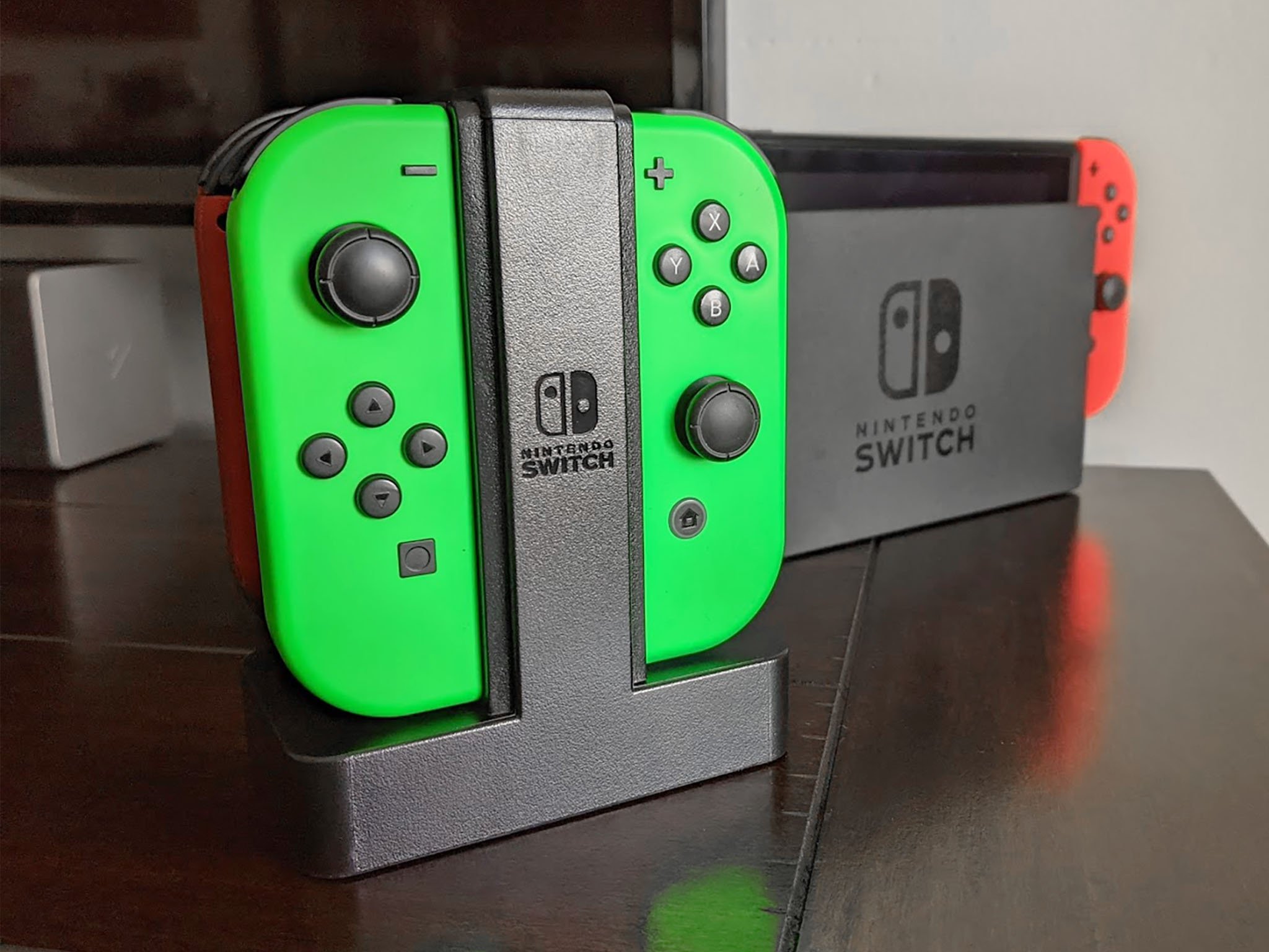 Powera Joycon Charging Dock In Front Of Switch Dock Brightened