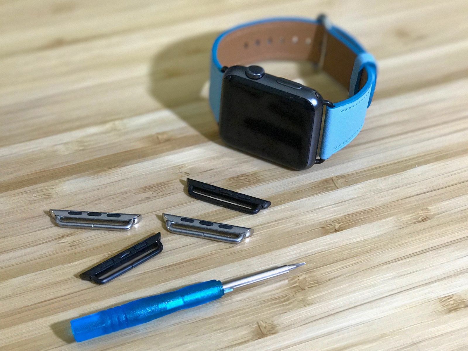 A Space Gray Apple Watch with custom, color-matched lugs.
