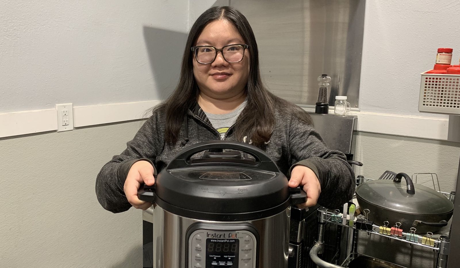 Christine Chan gladly holds up her Instant Pot, which is one of her favorite kitchen appliances