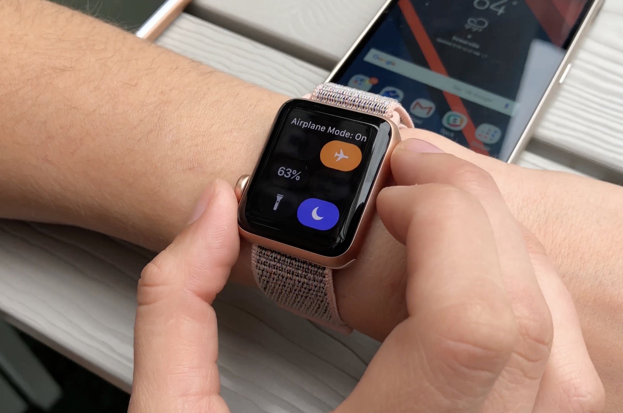  A person is using an Android phone to control an Apple Watch.
