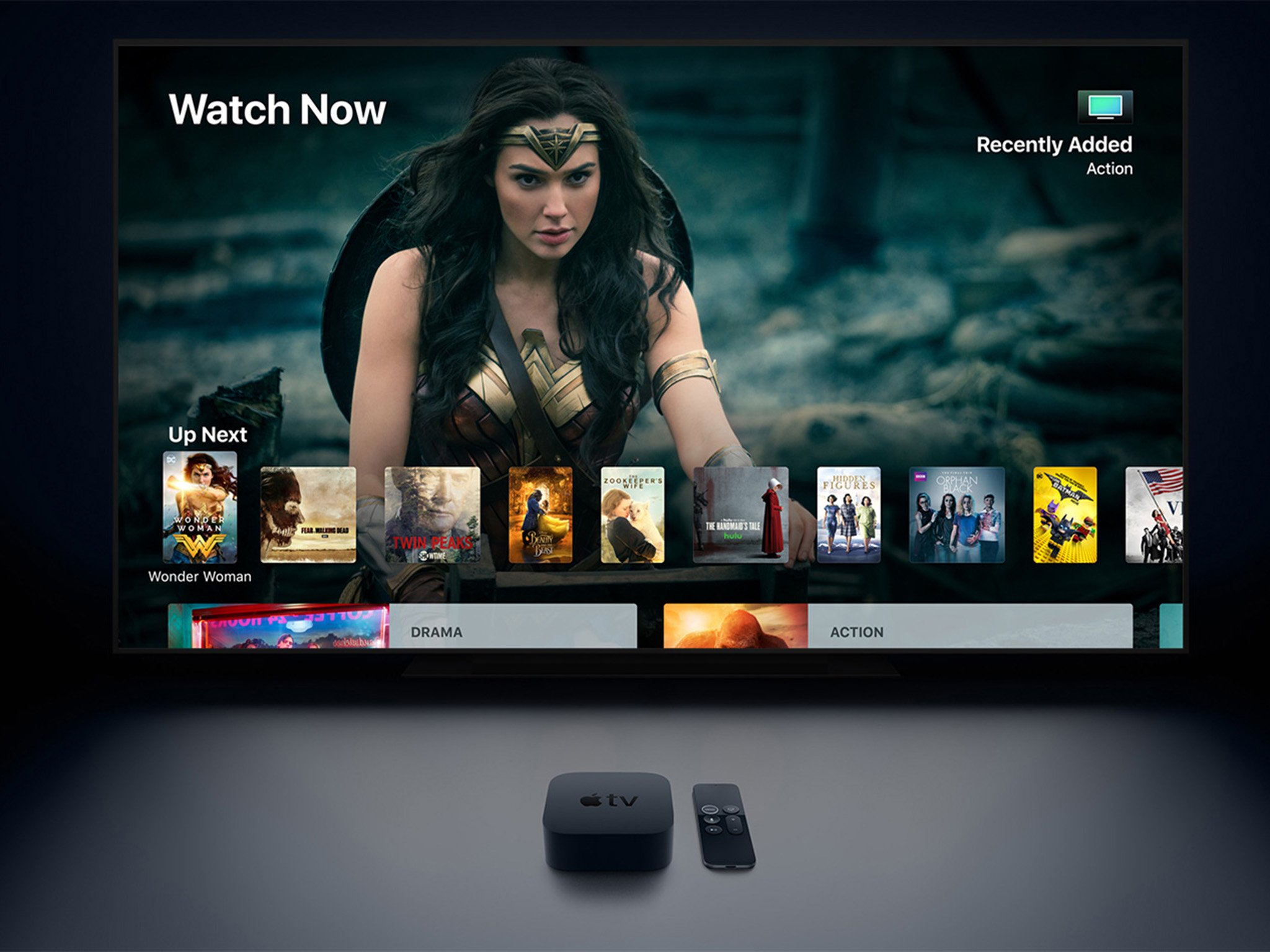 Apple TV 4K is shown sitting in front of a flat screen television.
