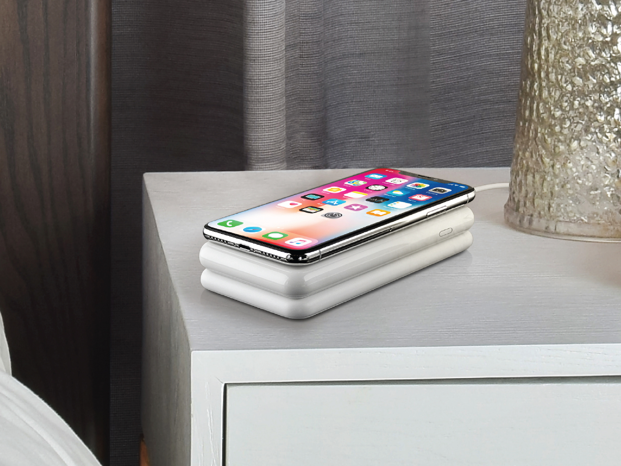 Avido&#39;s WiBa wireless charging system on a bedside table with an iPhone X resting atop it