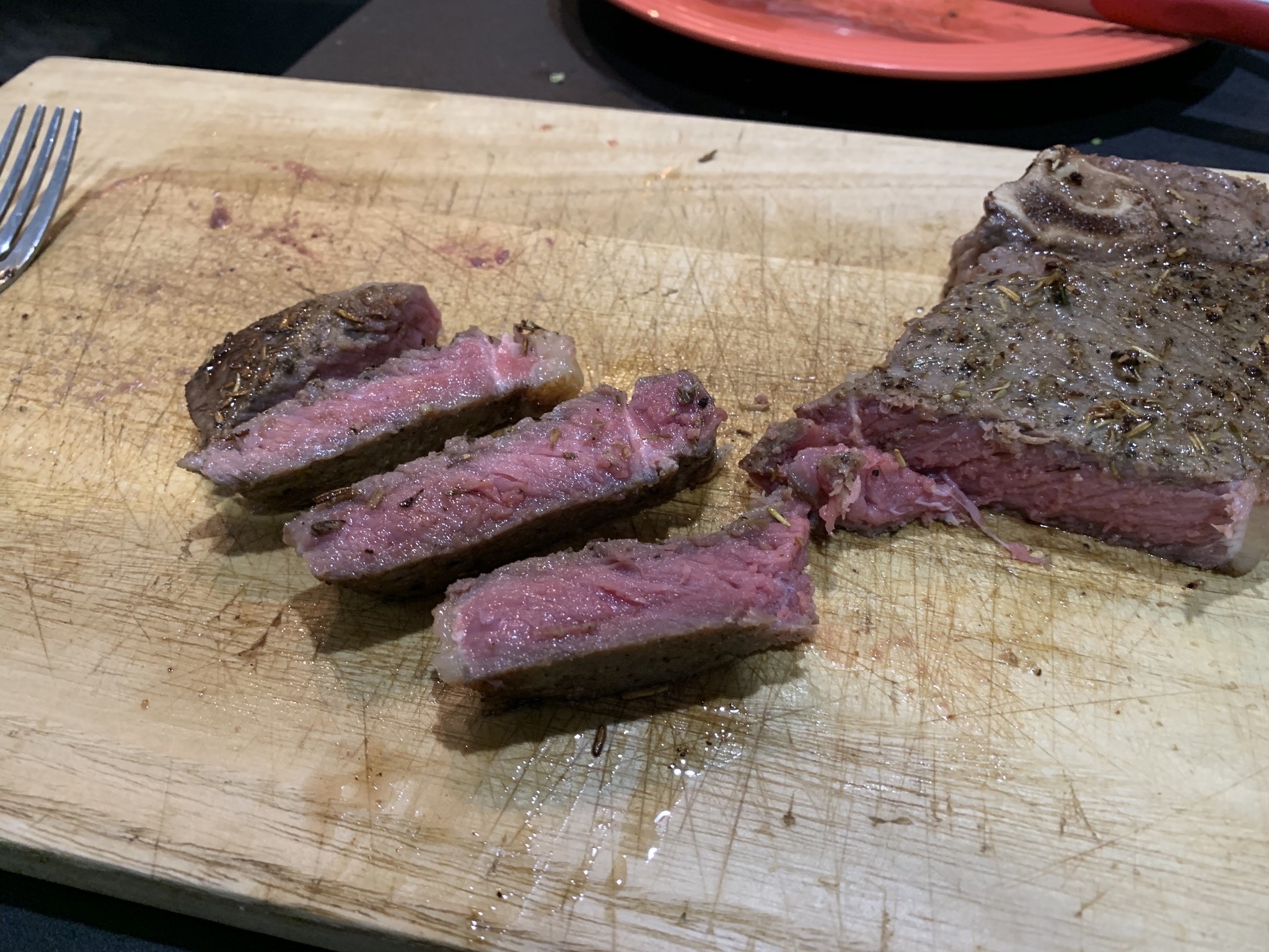 A rare steak cooked by sous vide and then seared in a cast iron skillet