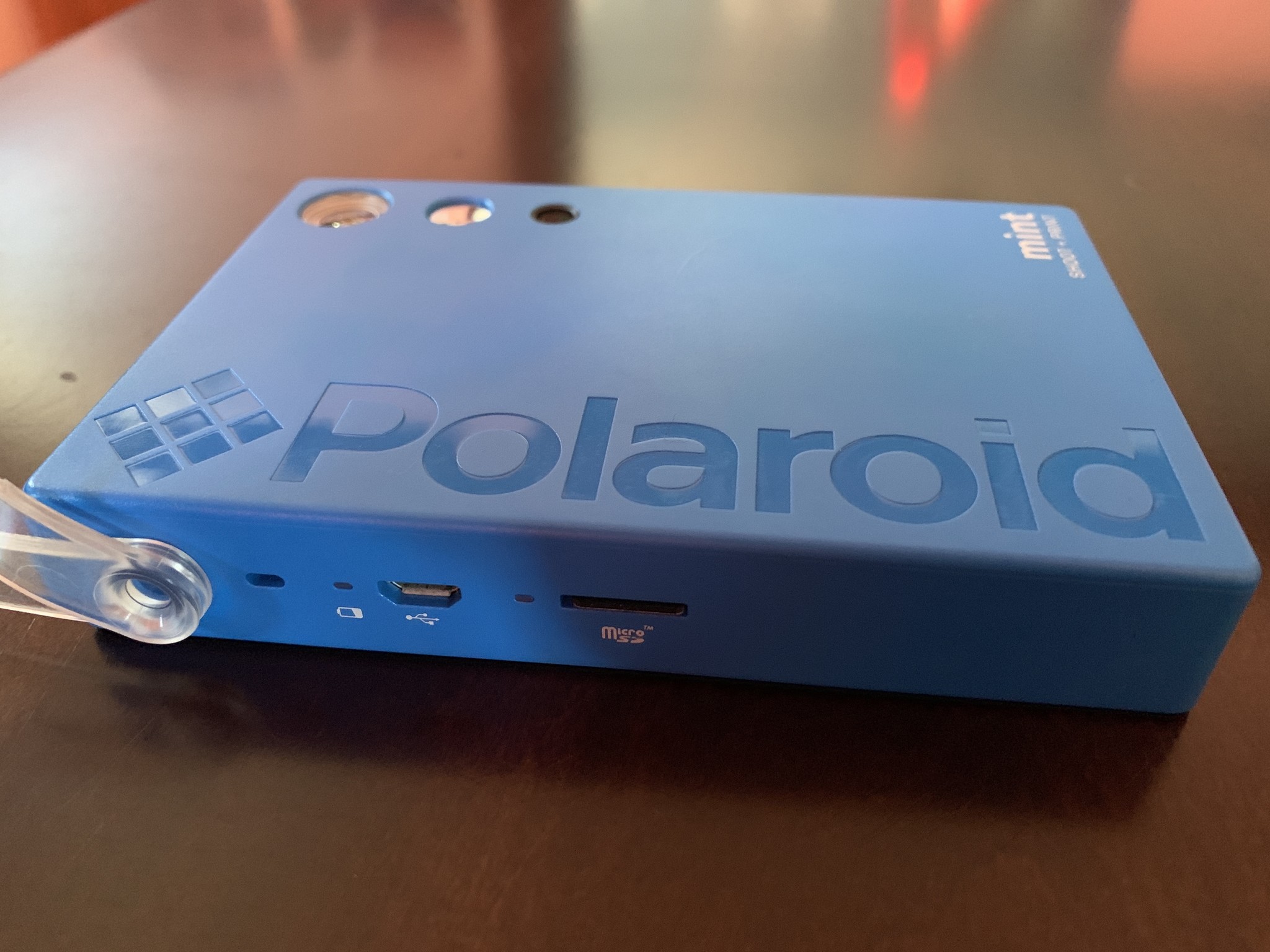 Blue Polaroid Mint Camera & Printer side where the power light and microSD card slot are